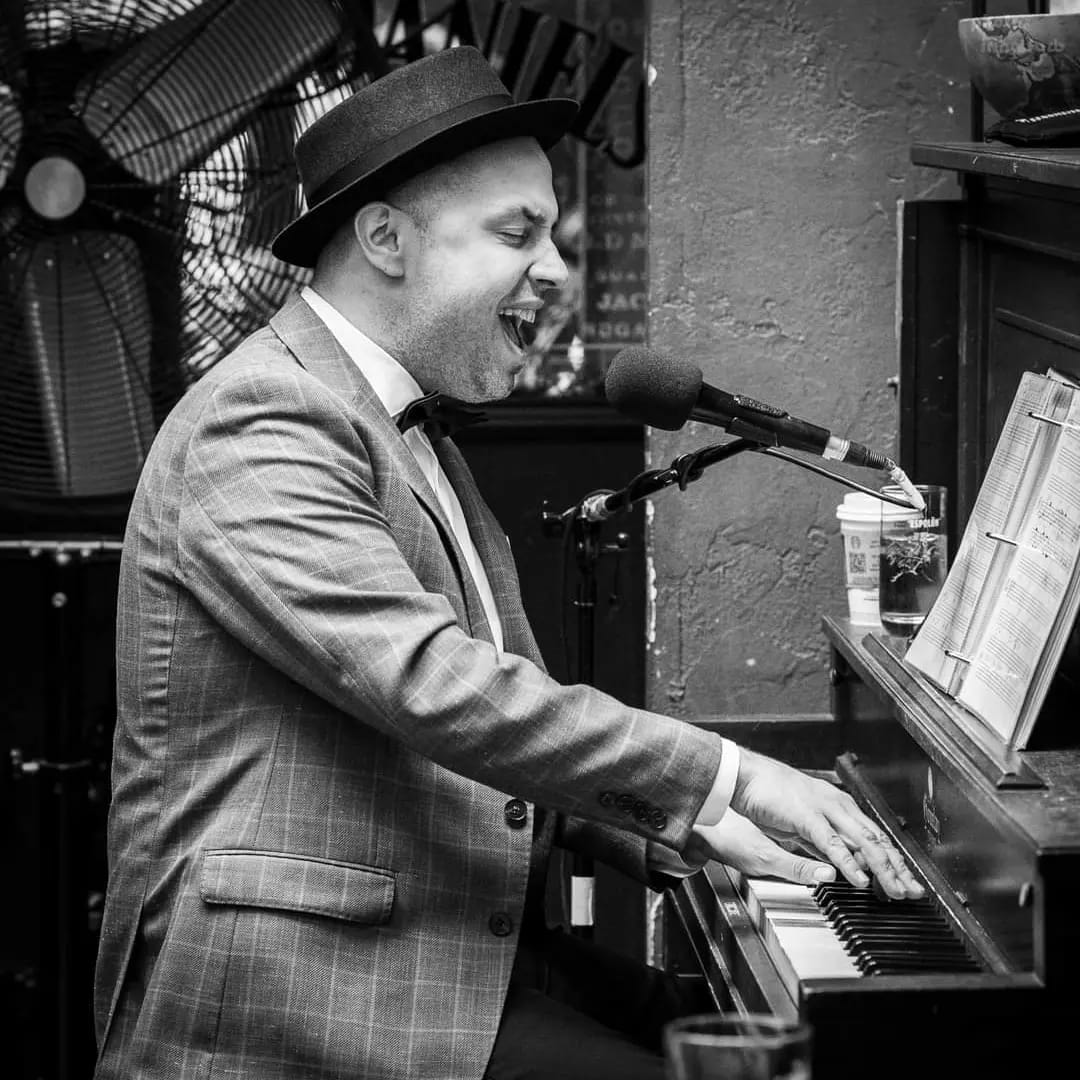 Sean Stanley playing the piano and singing